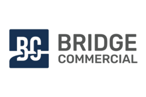 A blue and white logo for bridge commercial