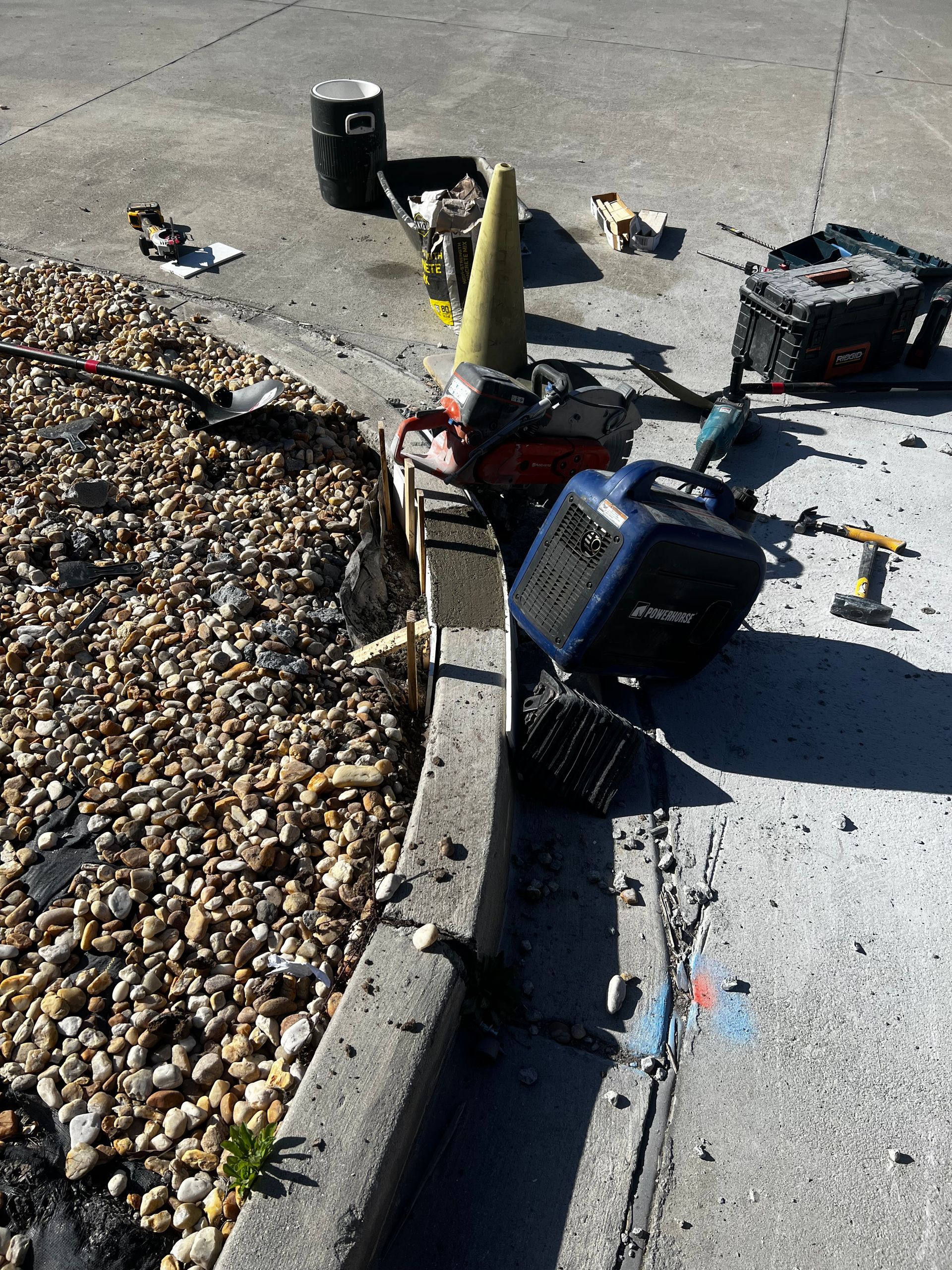 A lawn mower is sitting on the side of the road