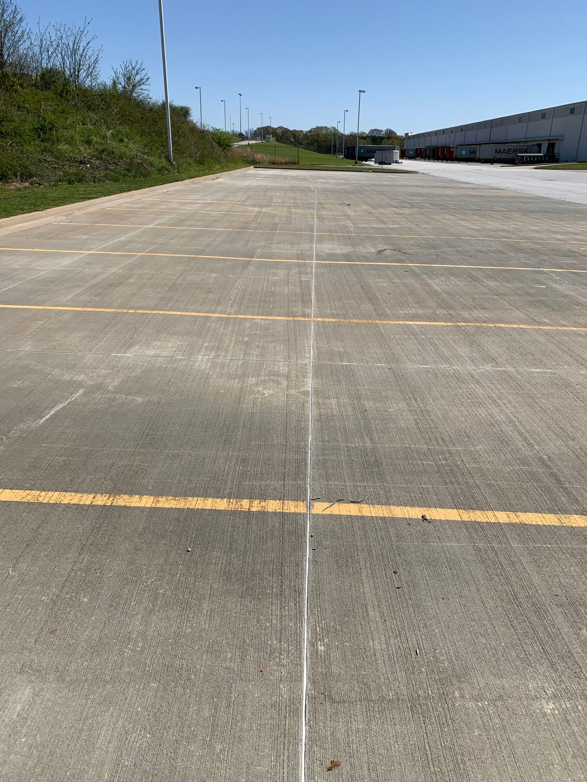 A concrete road with a yellow line on it