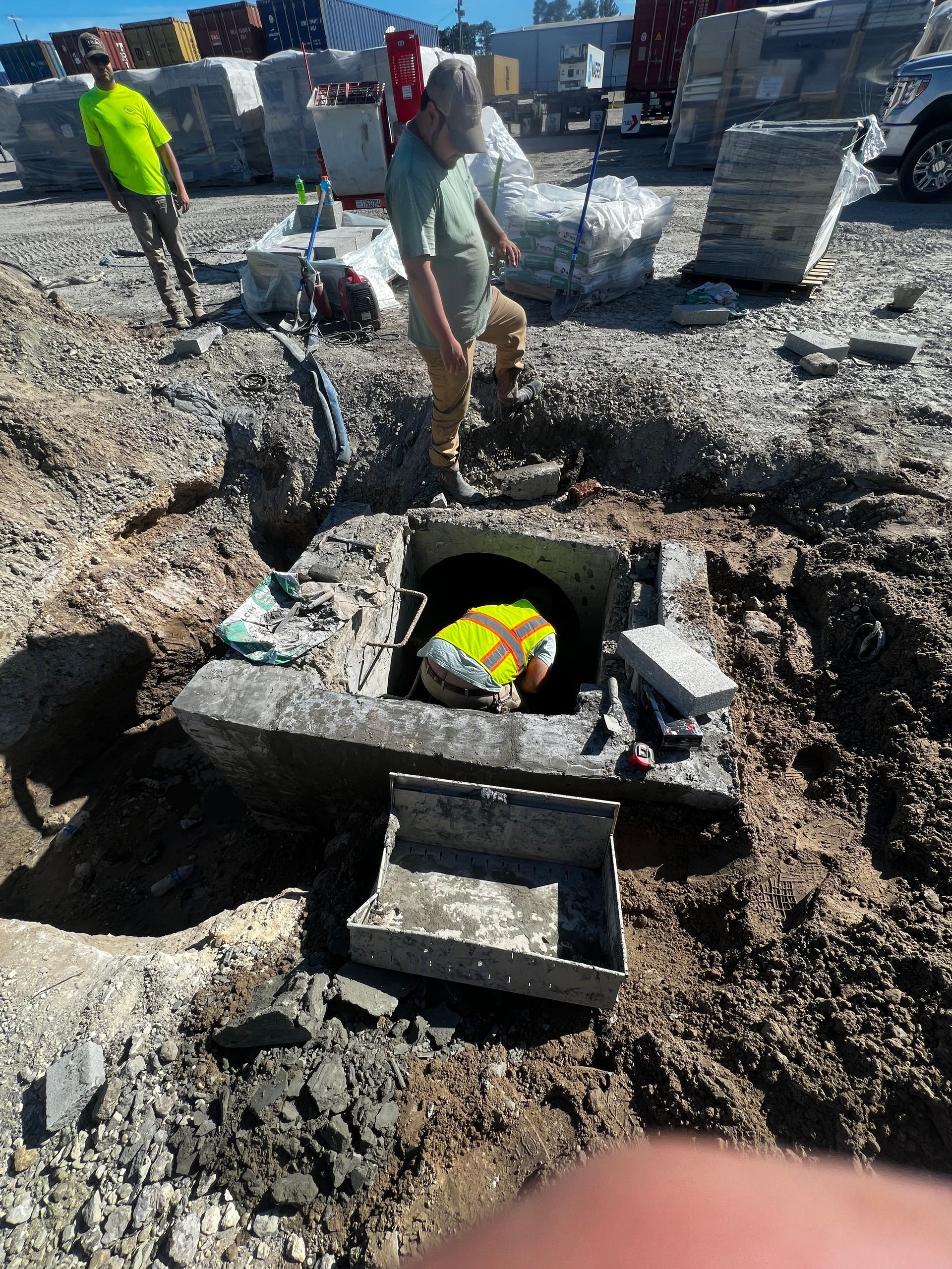 A man is standing in a hole in the ground.
