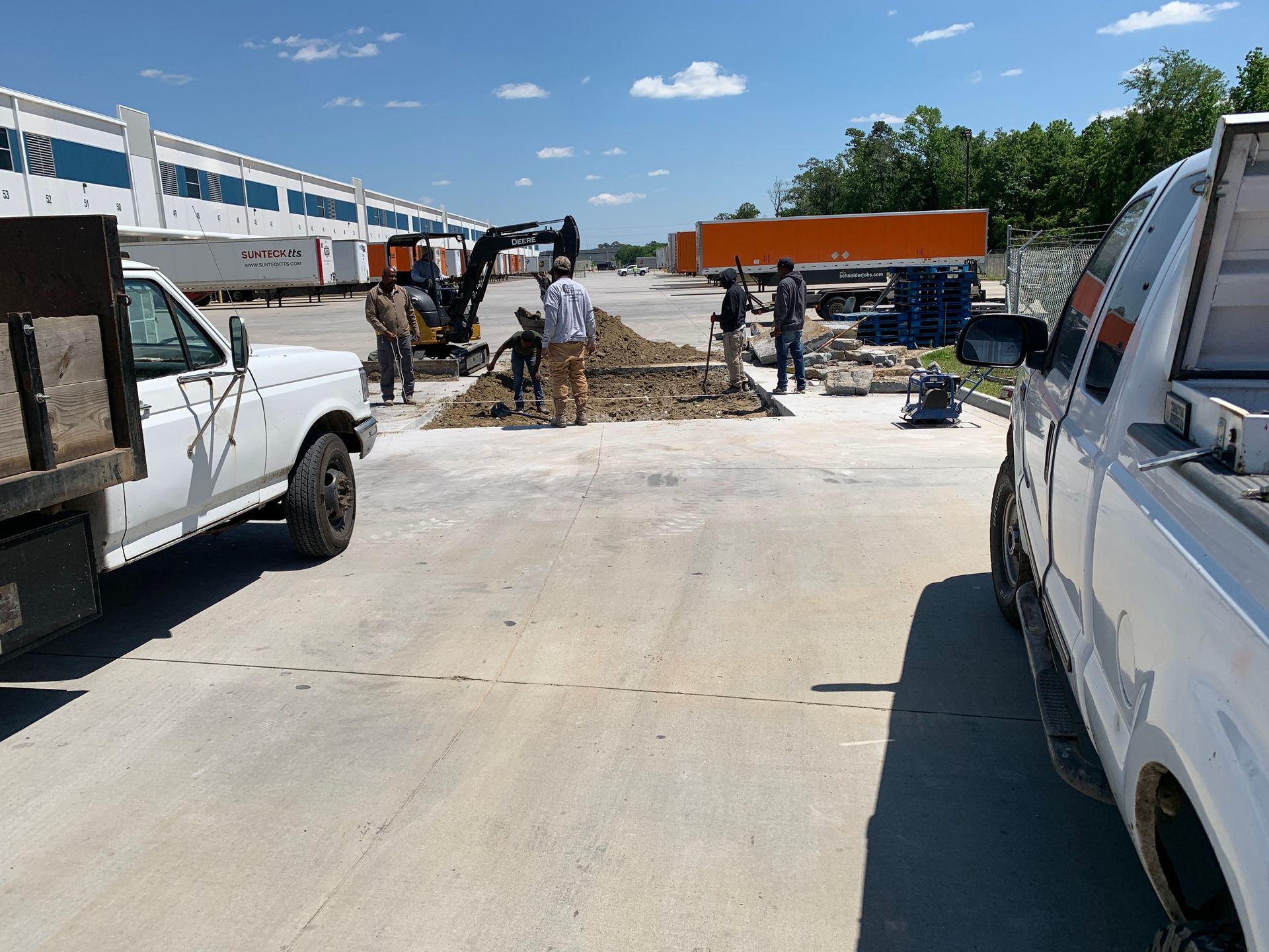 A white truck is parked in the middle of a construction site
