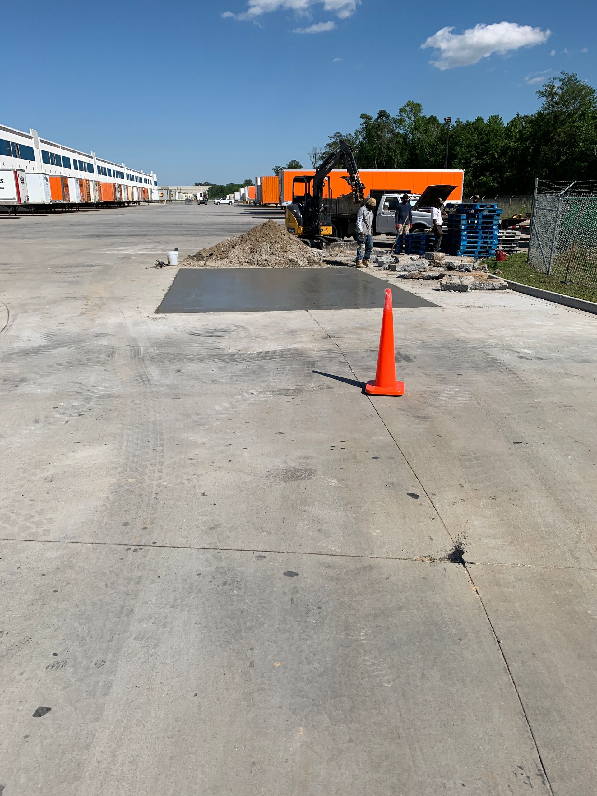 An orange cone is sitting on the side of a road