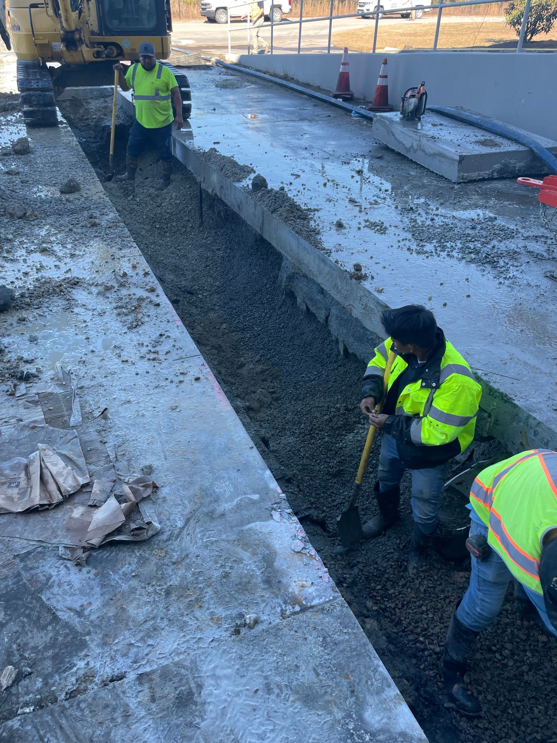 A group of construction workers are working on a road.