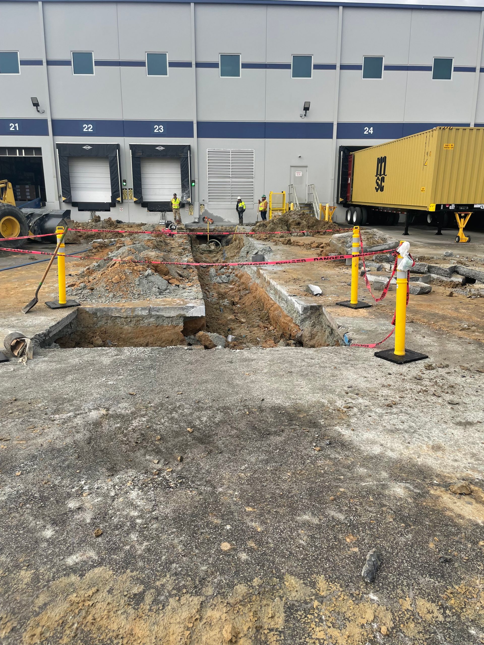 A large building with a lot of trucks parked in front of it