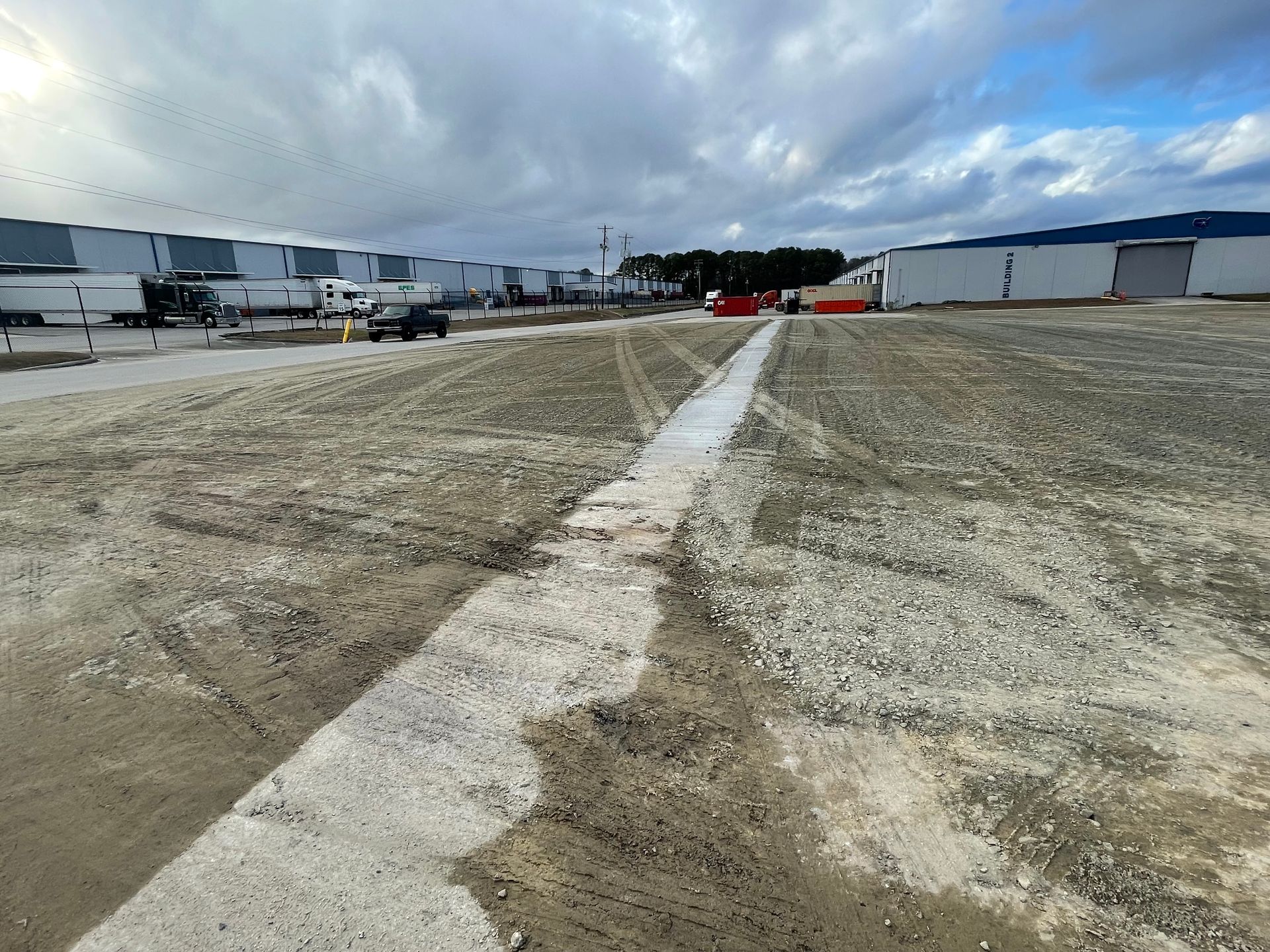 A lot of trucks are parked in a parking lot.
