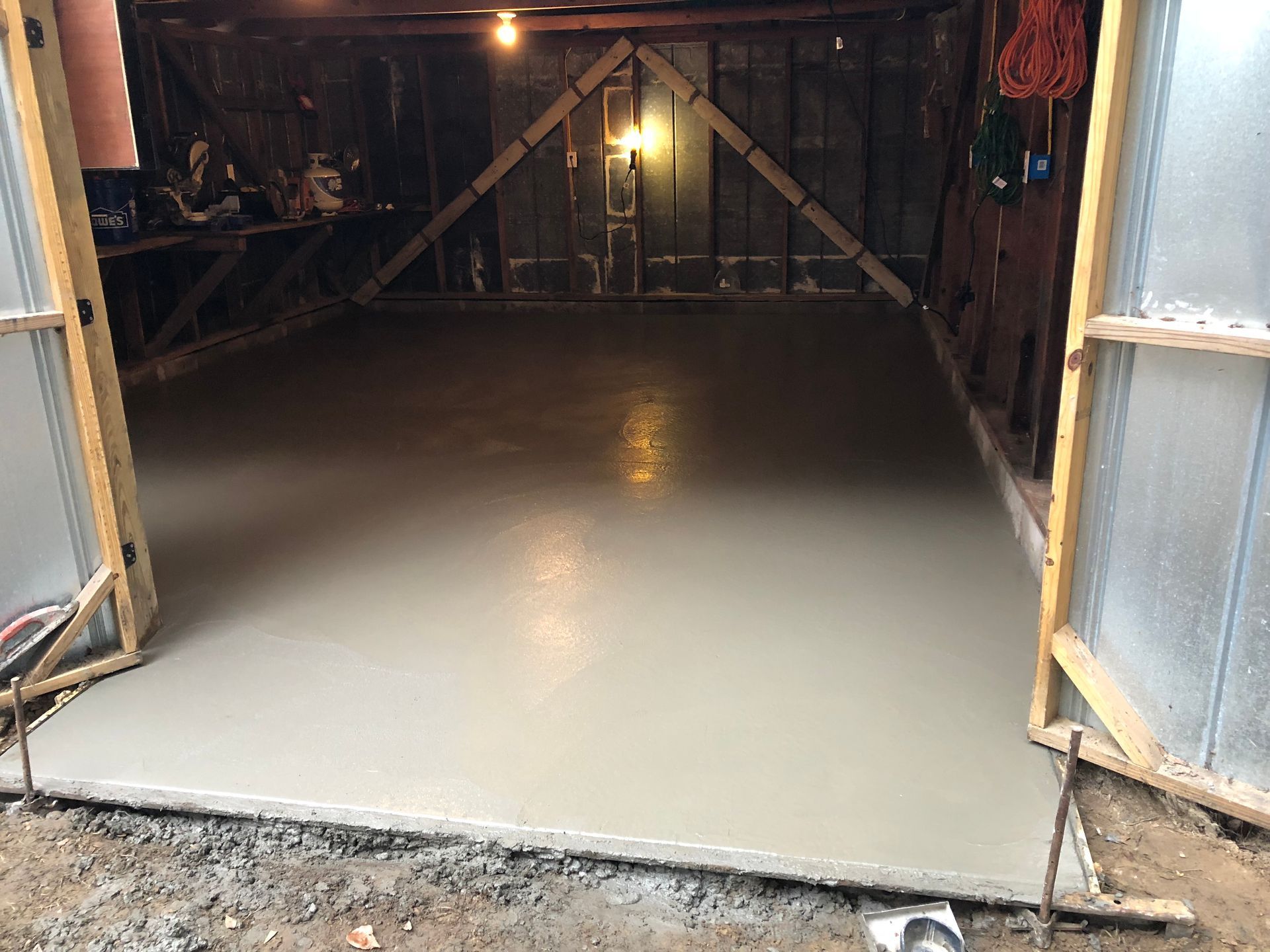 A concrete floor is being installed in a garage.