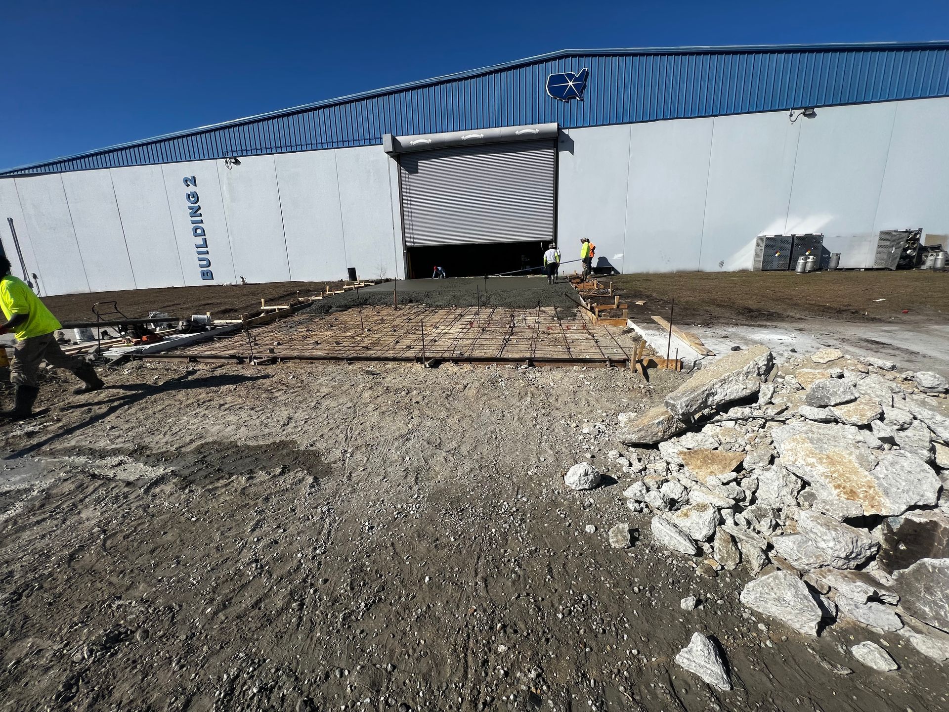 A construction site with a large building in the background