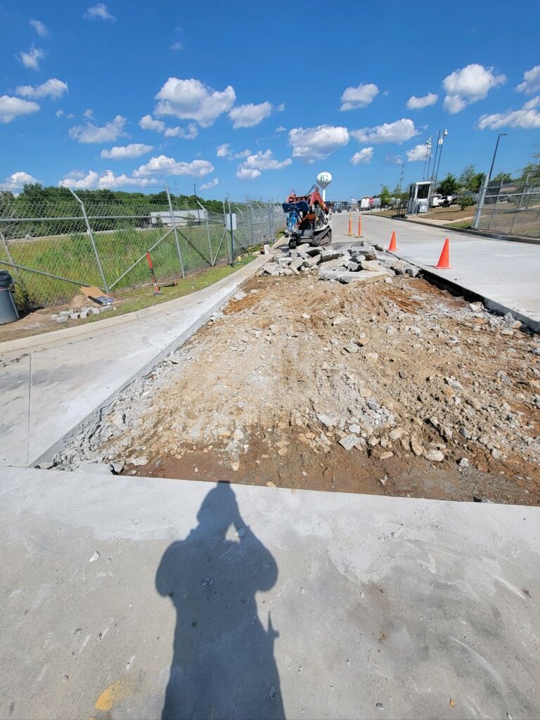 A shadow of a person is cast on a concrete surface.