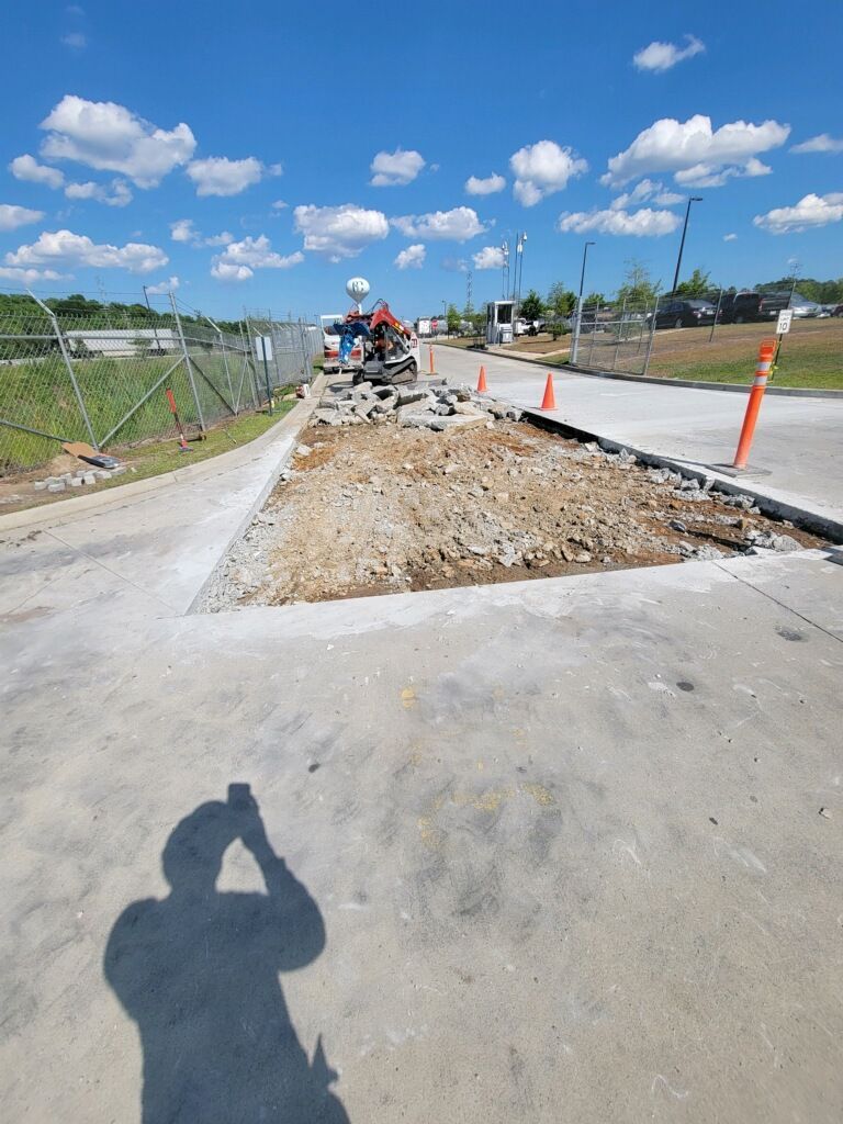 A shadow of a person taking a picture of a construction site.
