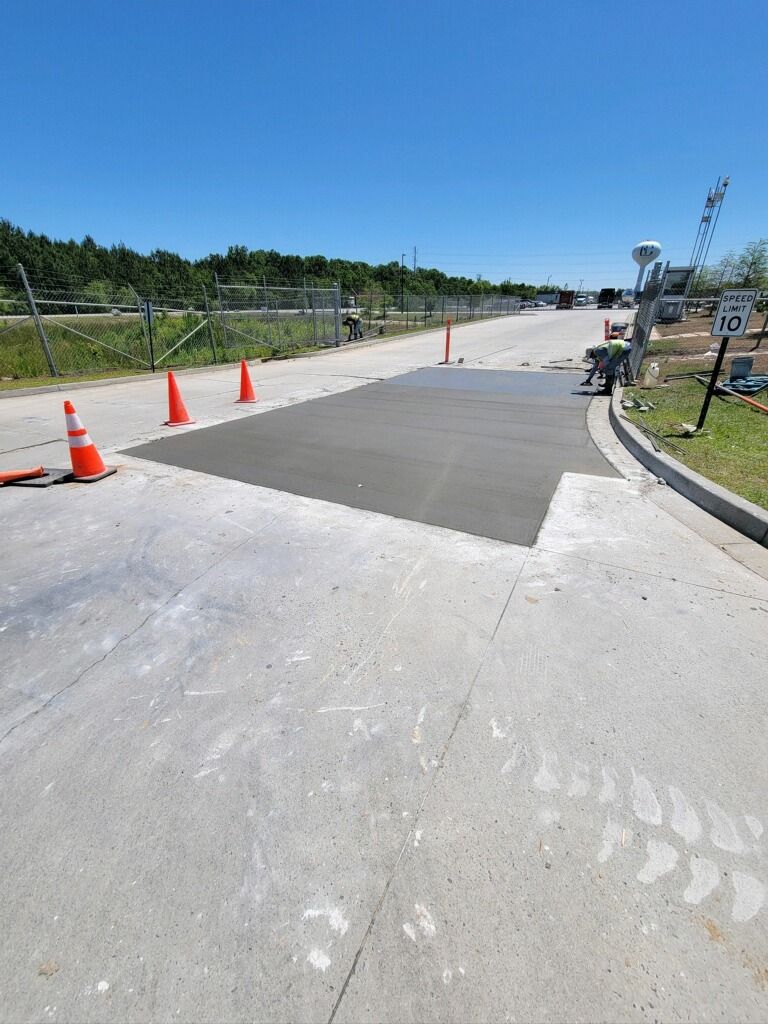 A concrete walkway is being built on the side of a road.