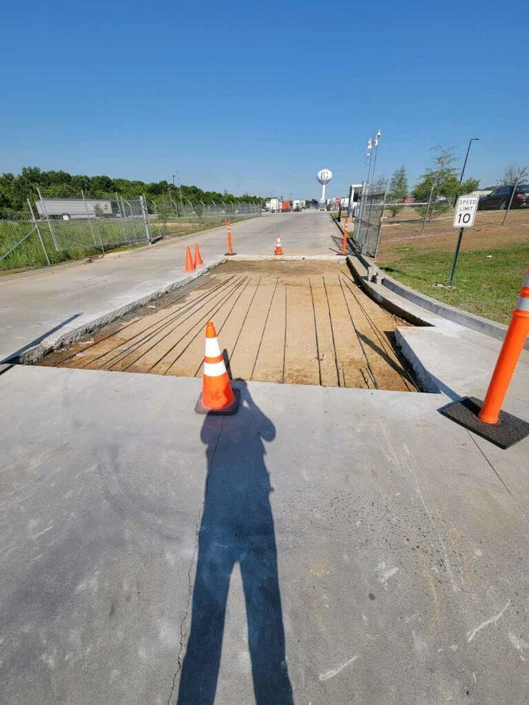 A shadow of a person is cast on a concrete surface.