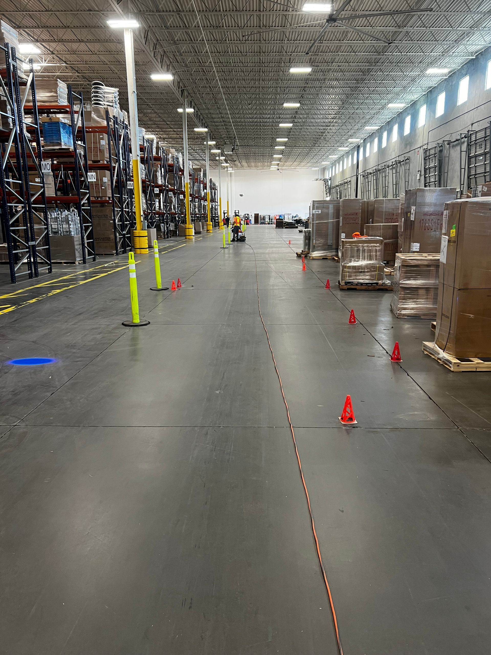 A large warehouse filled with lots of boxes and cones.