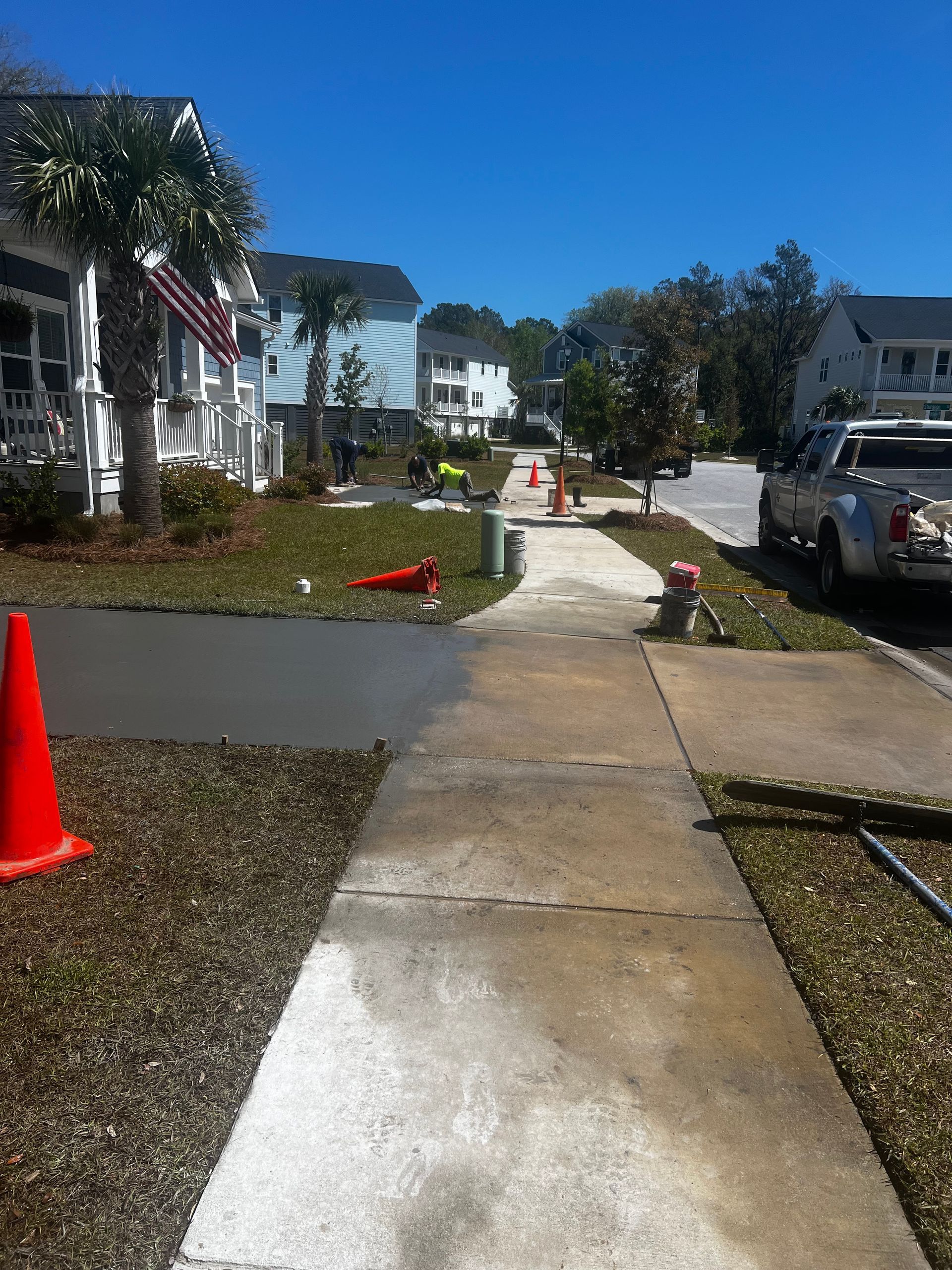 A sidewalk with a truck parked on the side of it