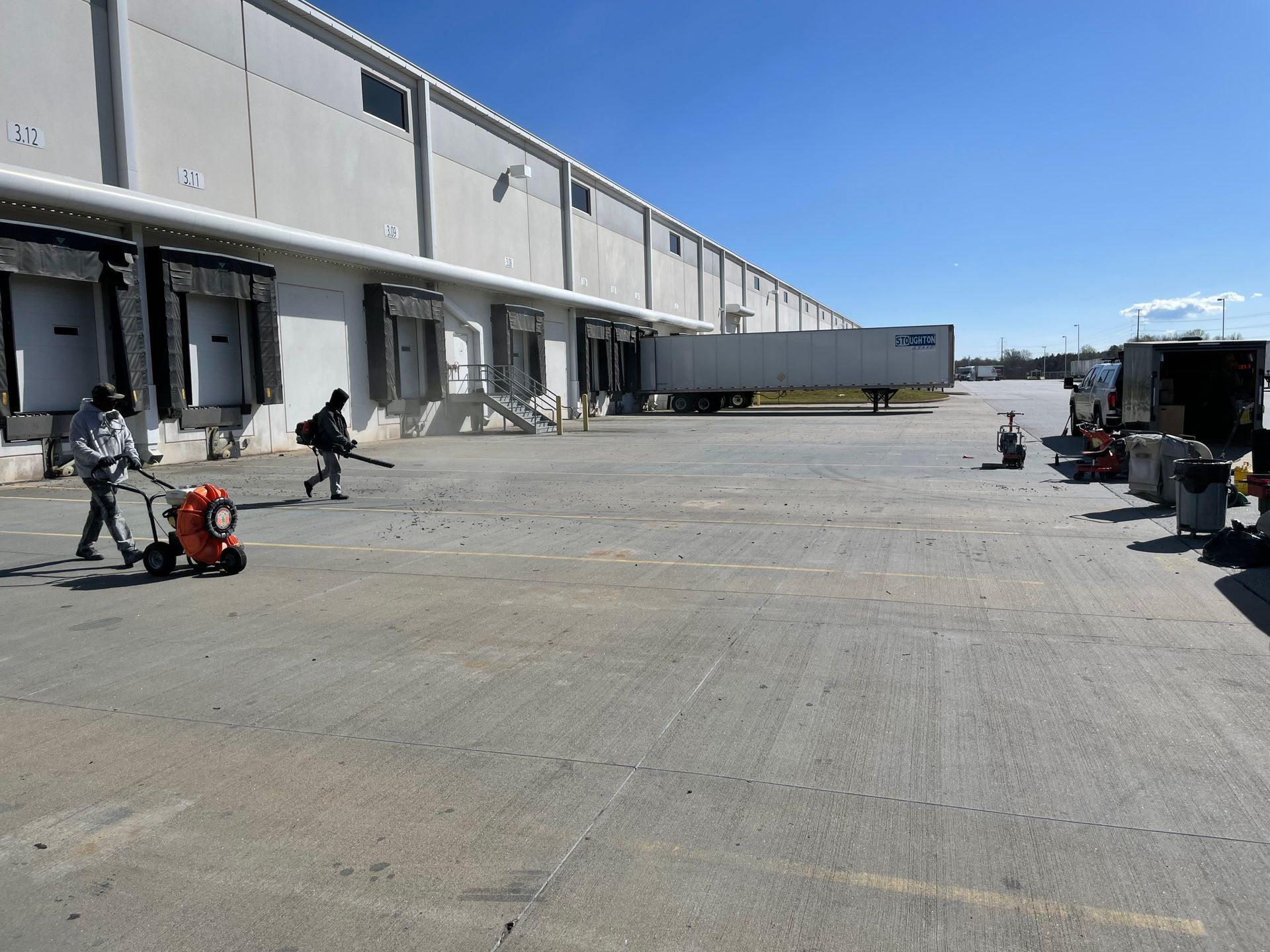 A warehouse with a truck that says ' dhl ' on it