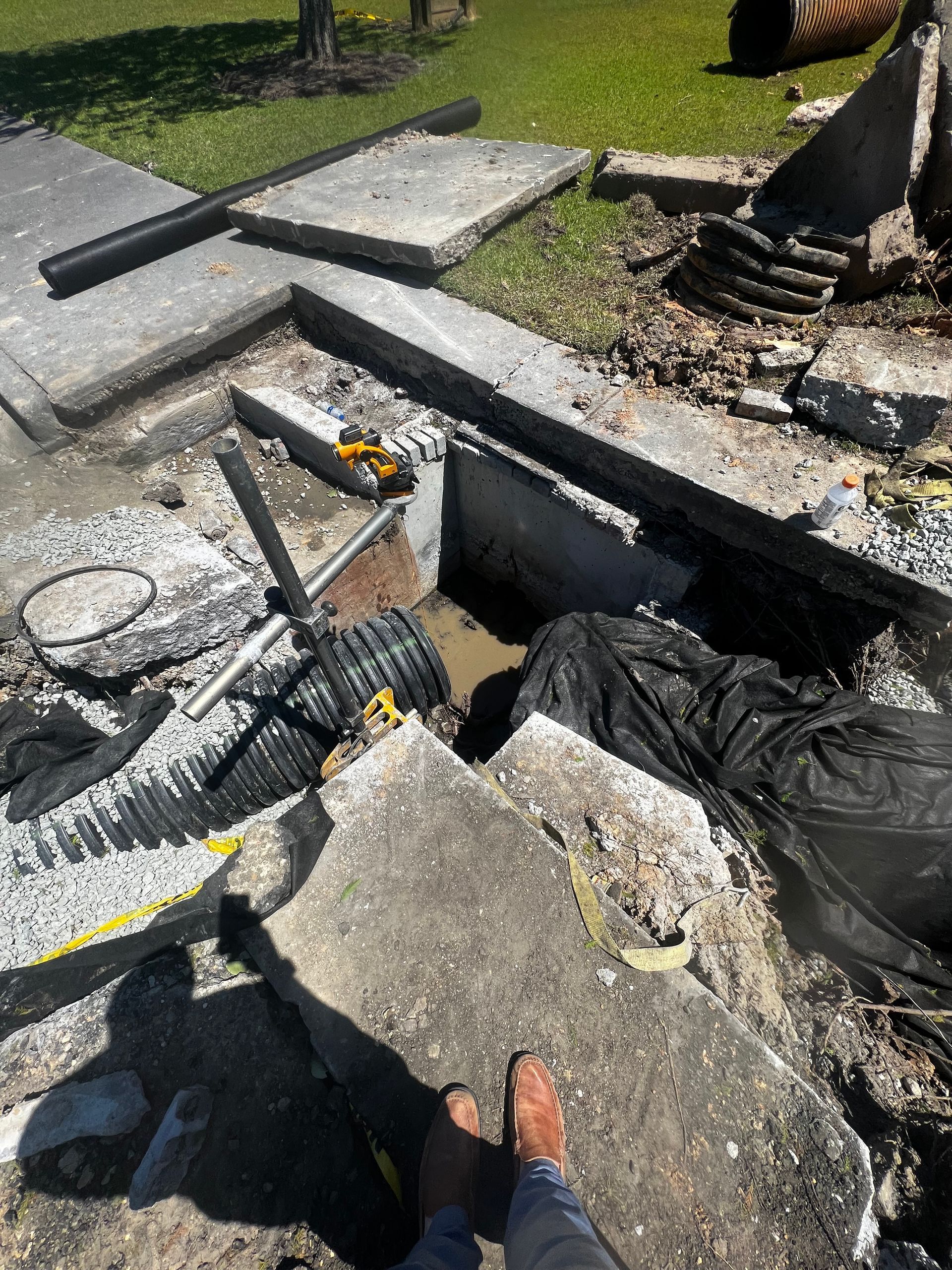 A person is standing on top of a pile of concrete.