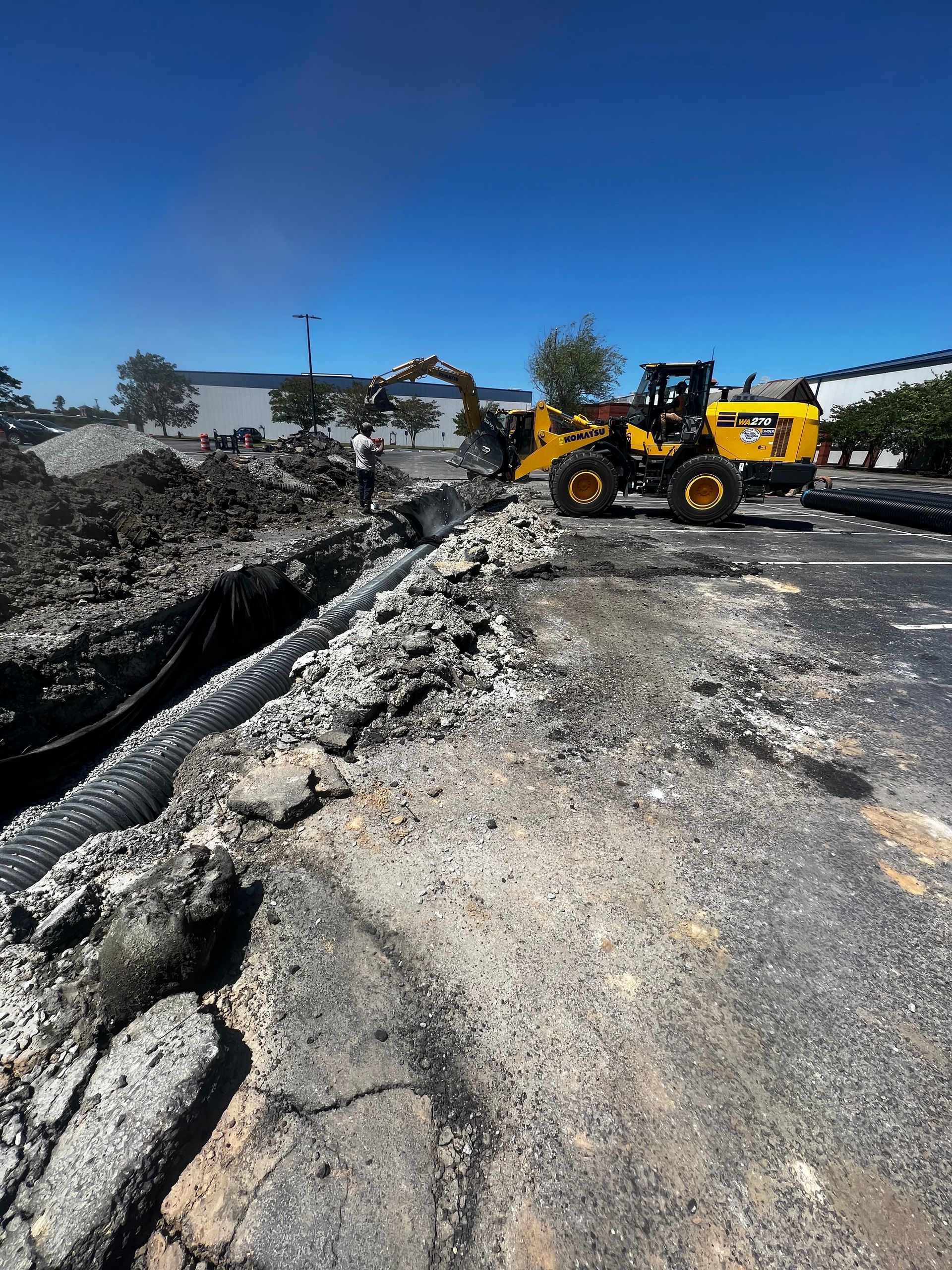 A bulldozer and a tractor are working on a road.