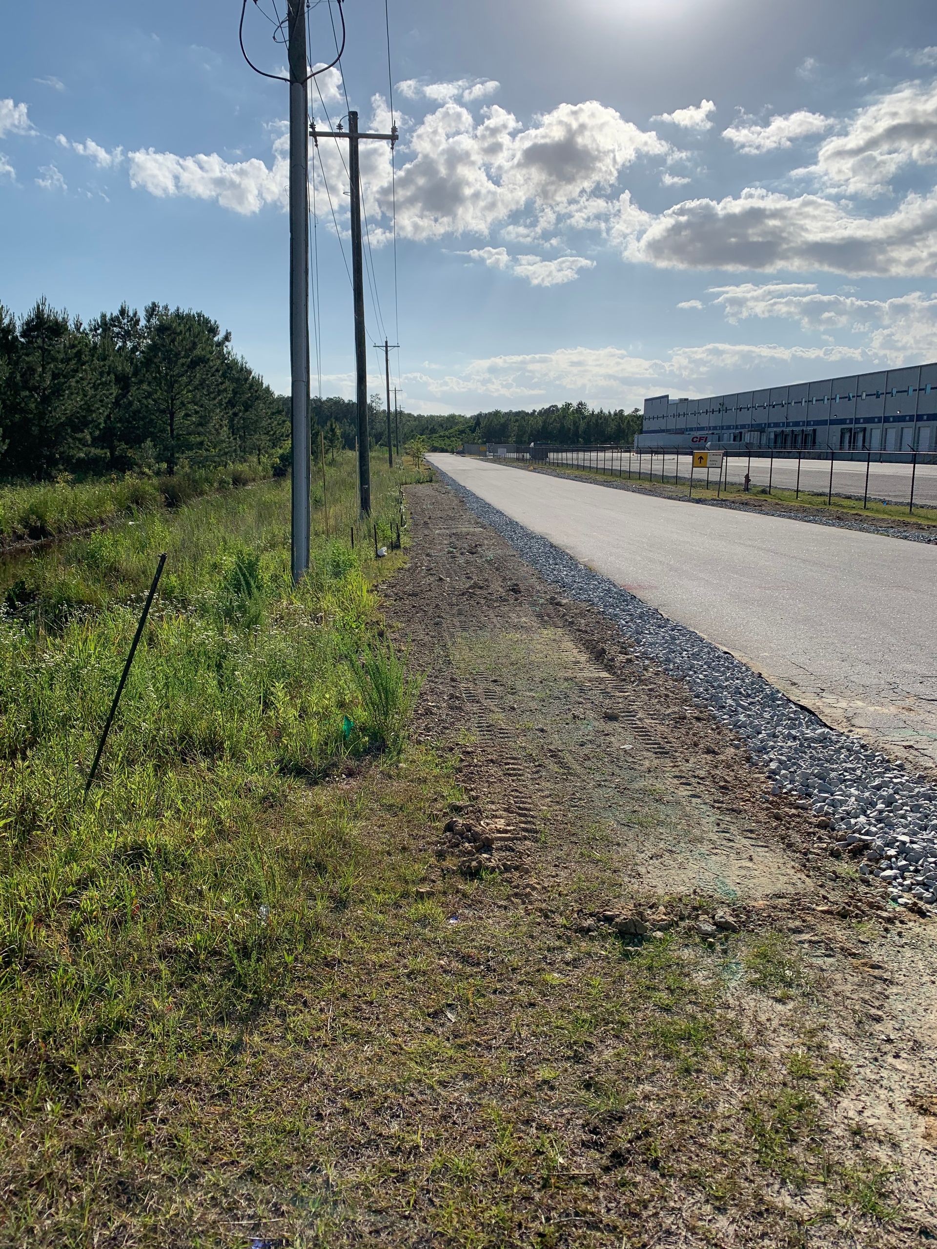 A road with a lot of grass on the side of it
