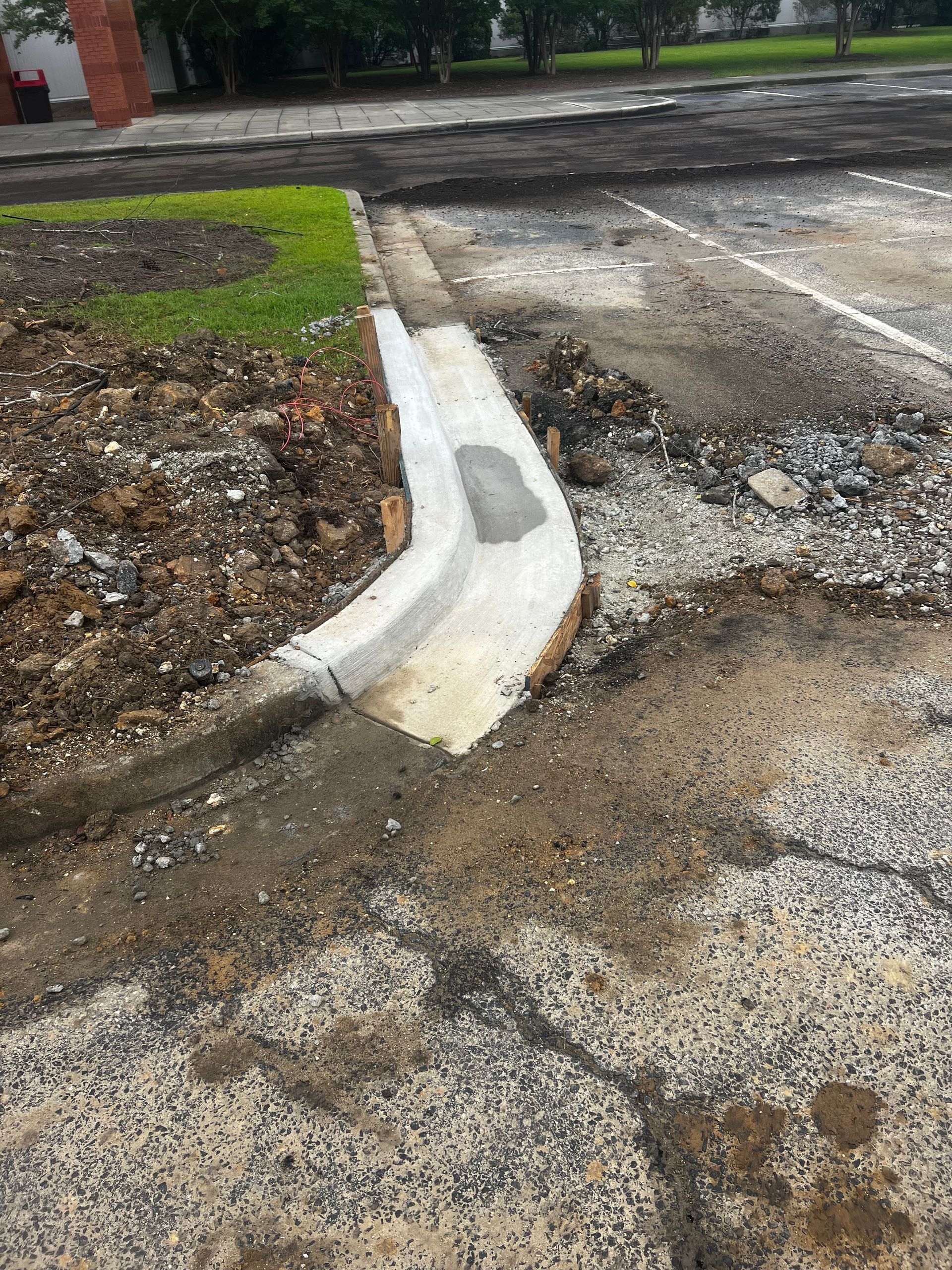 A curb is being installed on the side of a road.