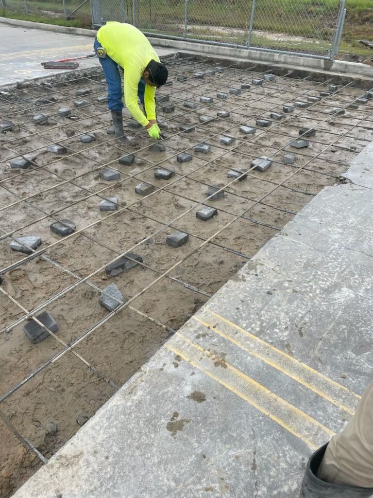 A man is working on a concrete surface.