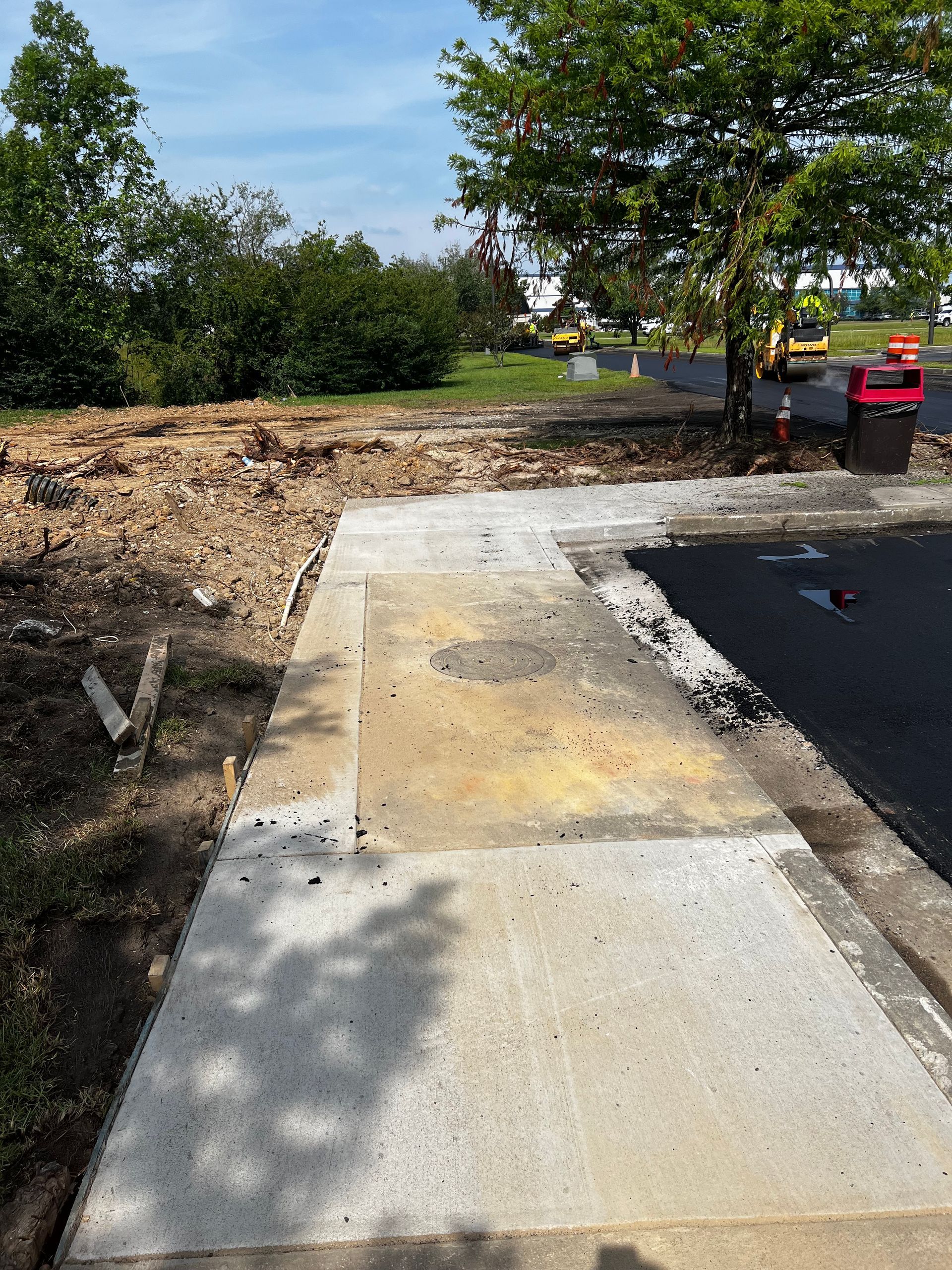 A concrete walkway is being built next to a parking lot.