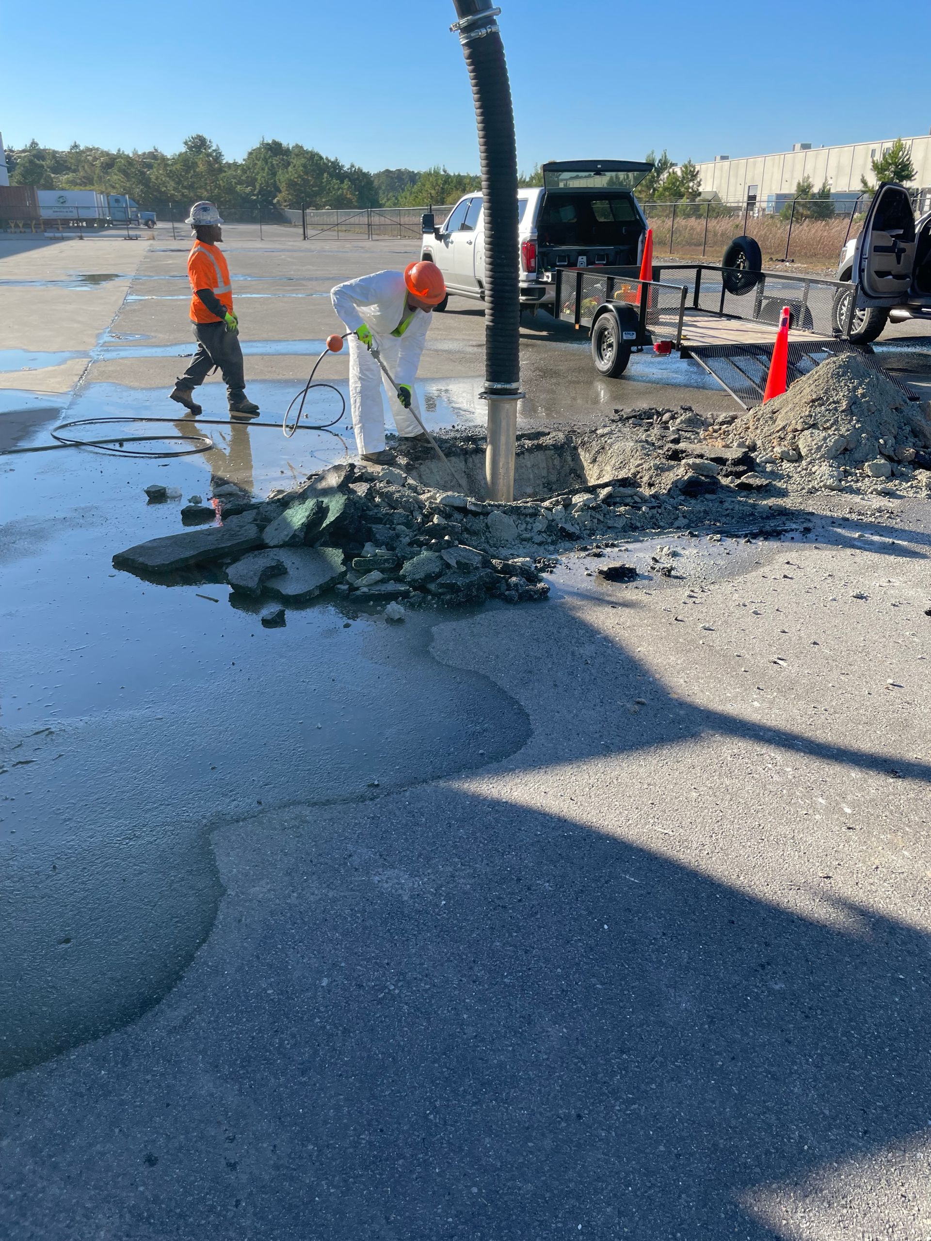 A group of construction workers are working on a road.