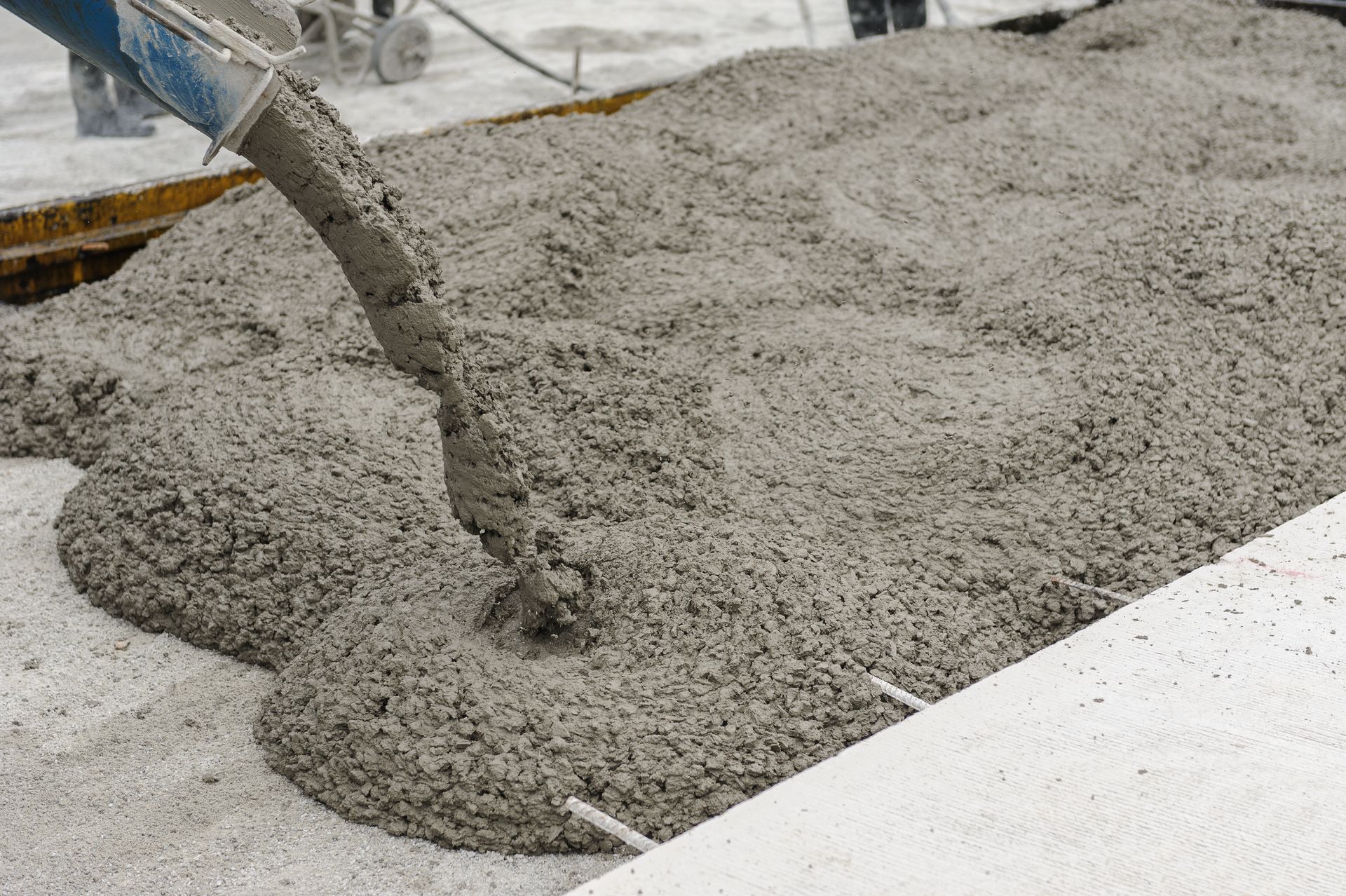 Ready-mix concrete being poured from a boom pump.