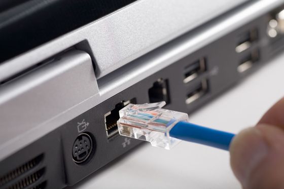 Closeup of a person plugging in an ethernet cord, symbolizing effortless integration