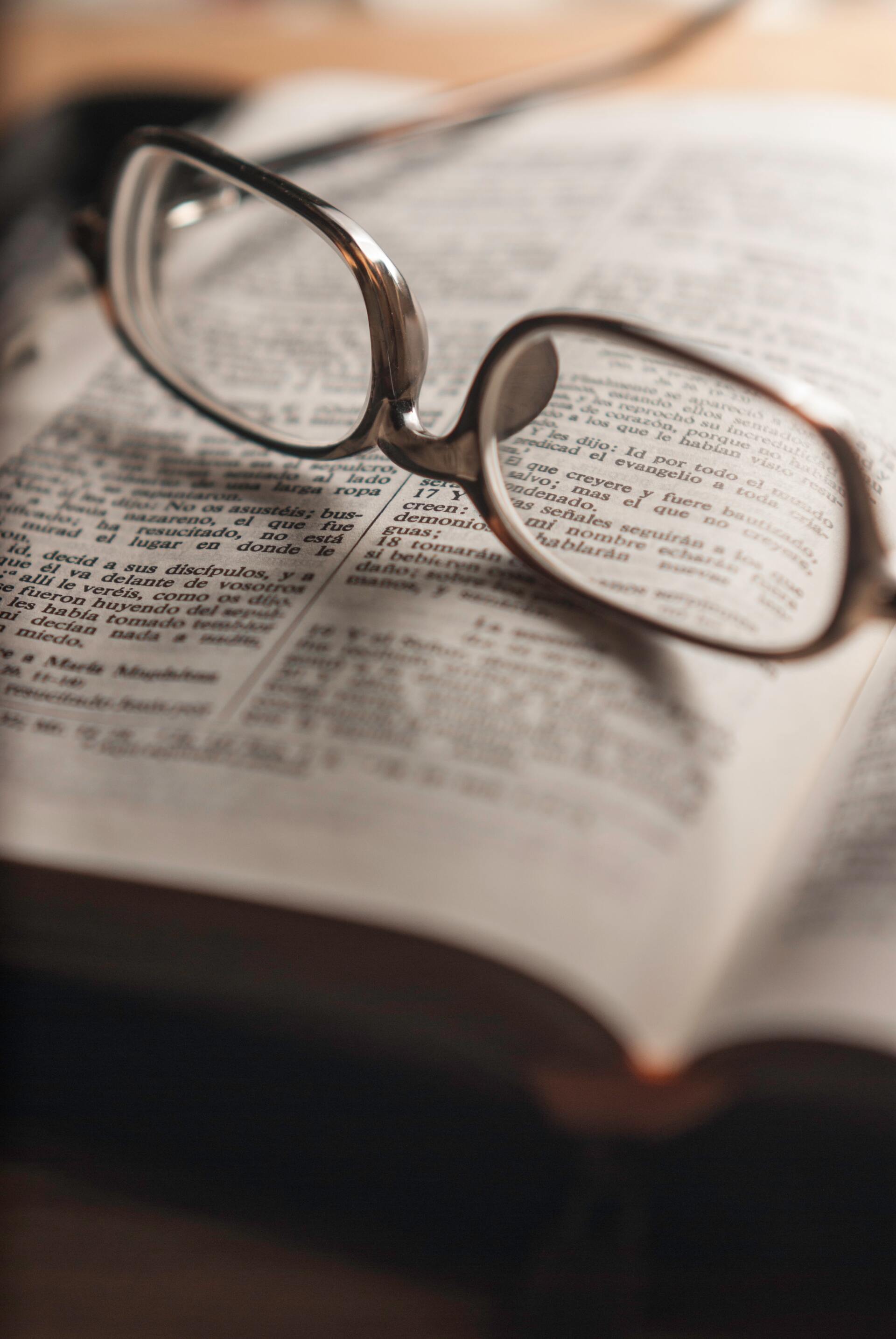 Glasses on book — Optometrist in Banora Point, NSW