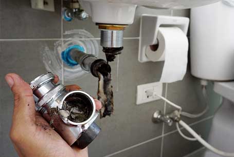 Worker Repairs the Bathroom Sink — Boca Raton, FL — Boca Certified Plumbing