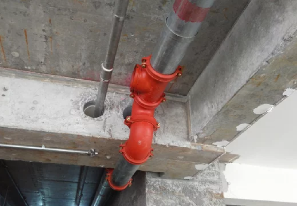 Sprinkler system pipe hanging from the slab soffit.