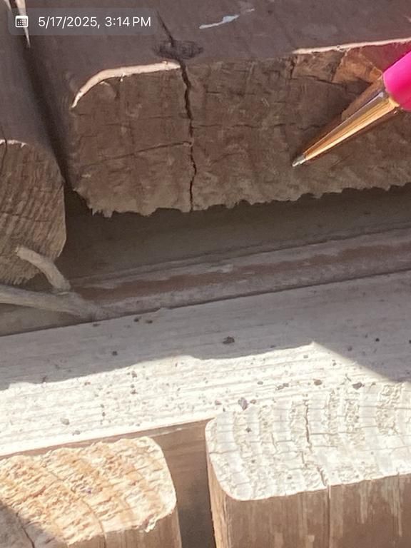 A pencil is pointing at a piece of wood.