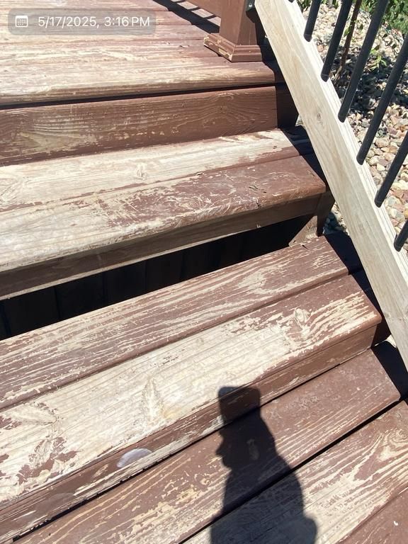 A wooden deck with a shadow of a person on it