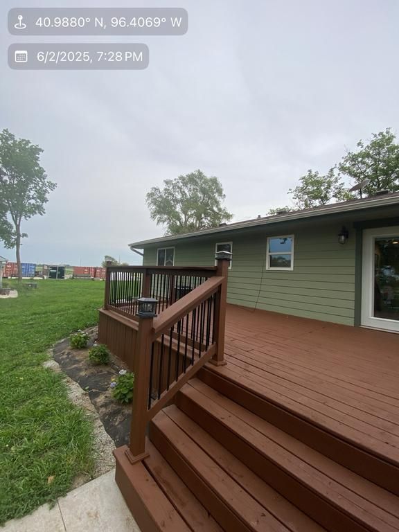 A picture of a house with a deck and stairs