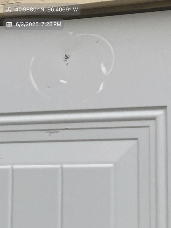 A close up of a white door with a heart shaped hole in it