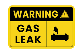 A yellow and black sign that says warning gas leak