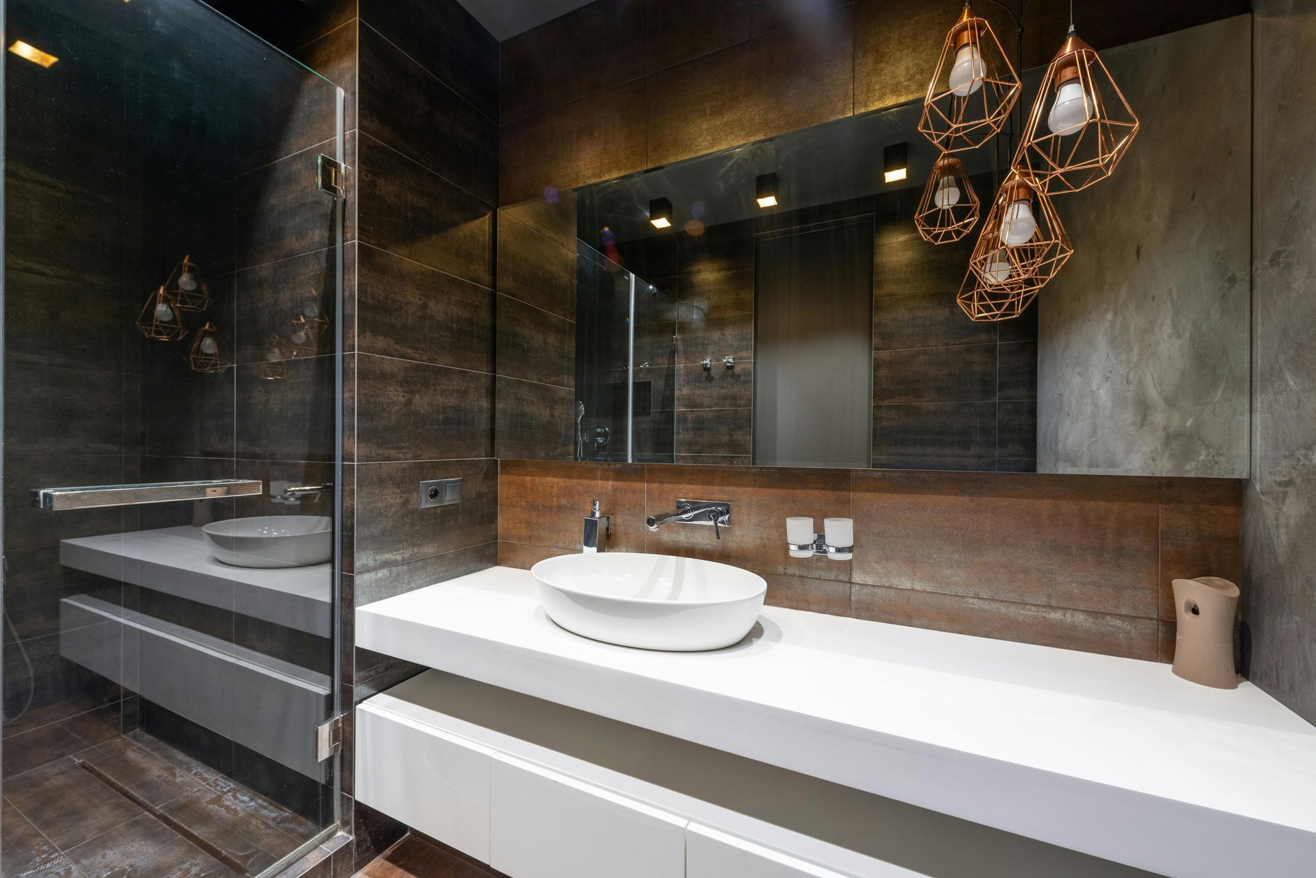 A bathroom with a sink and a large mirror.