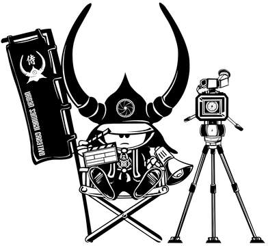 A cartoon character wearing a horned helmet and directing a film. Holding a clapperboard, bullhorn, and banner, next to a camera on a tripod.