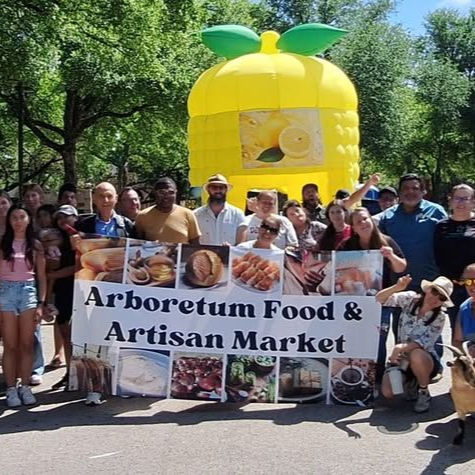 Group of people at an outdoor market posing with a 