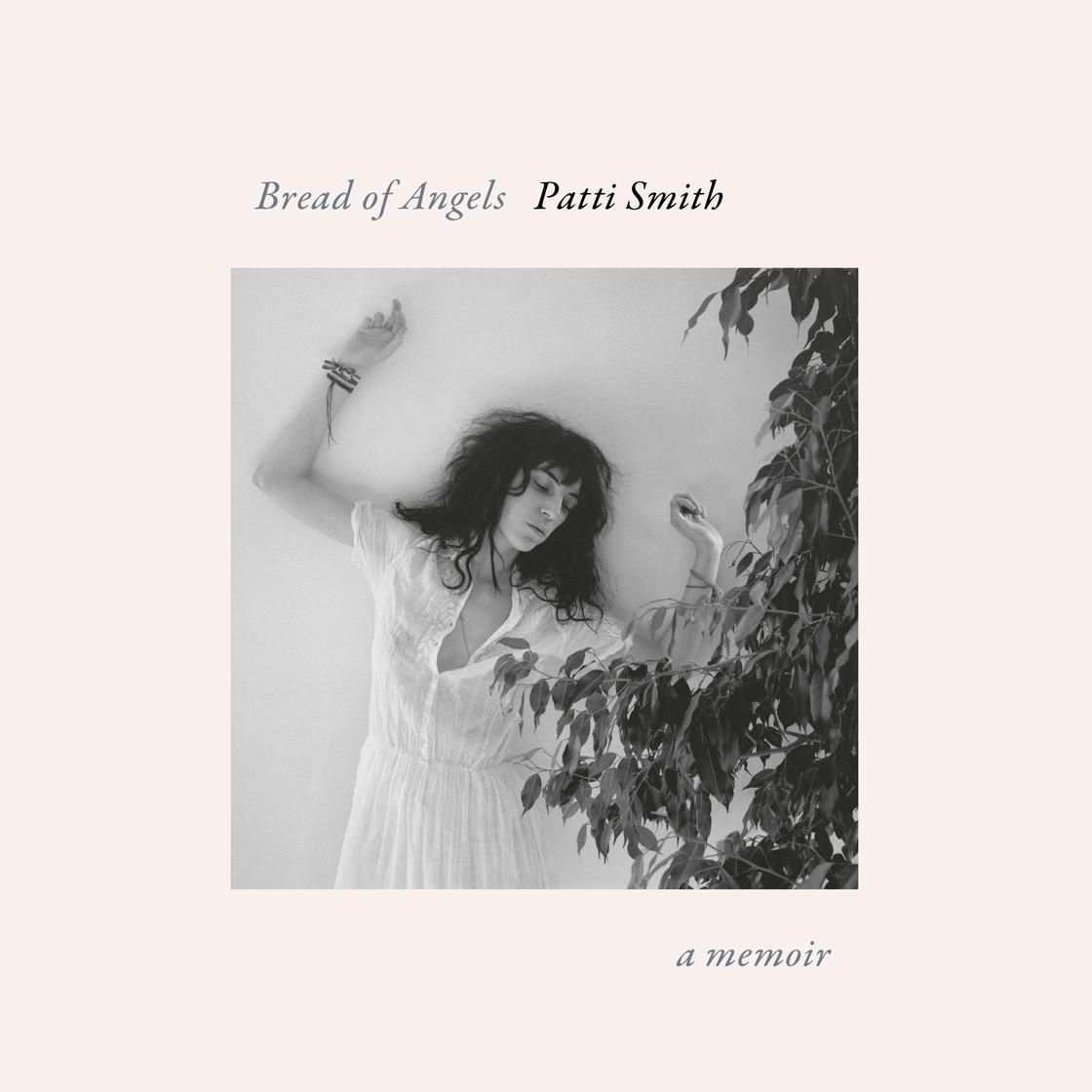 Album cover: Patti Smith in white dress, leaning against wall with leafy vines.