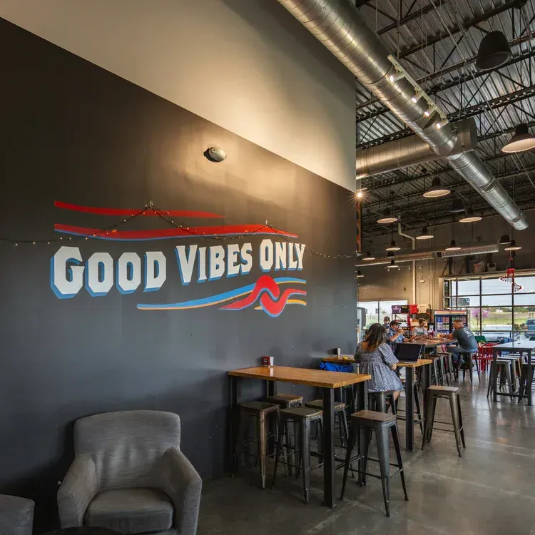 An indoor coffee shop with graphics on the wall