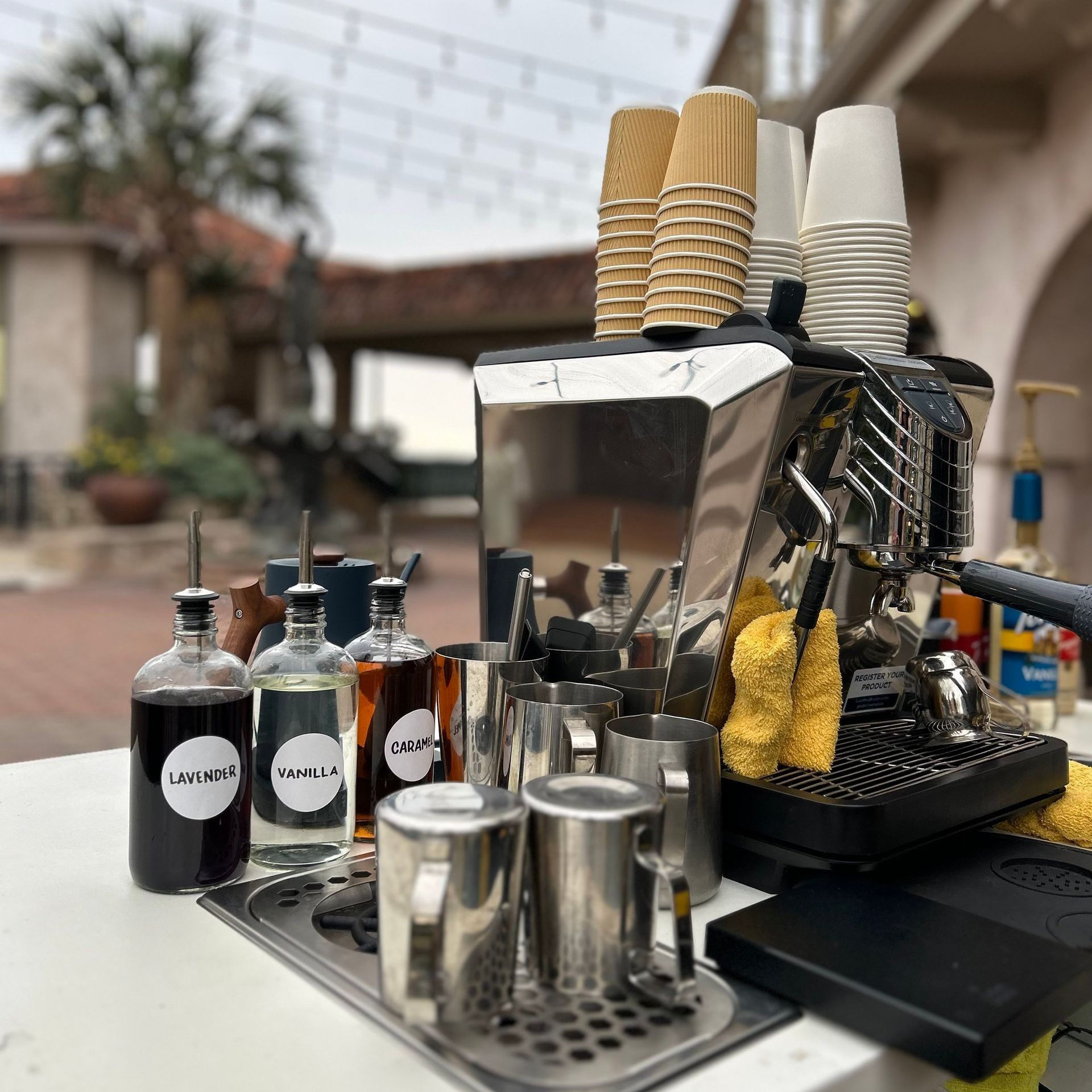 A coffee cart is outside near a building