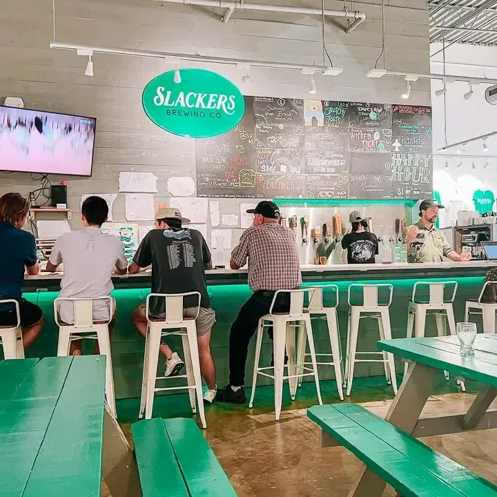 People sitting at a bar with green decor