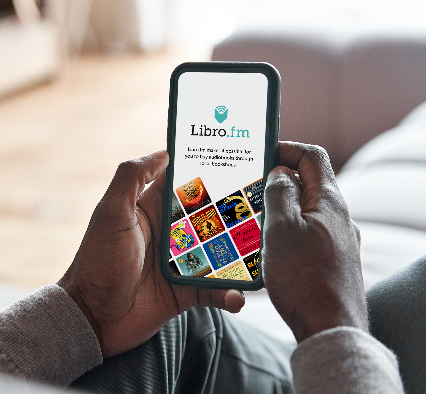 A person is holding a cell phone that says libro.fm on it