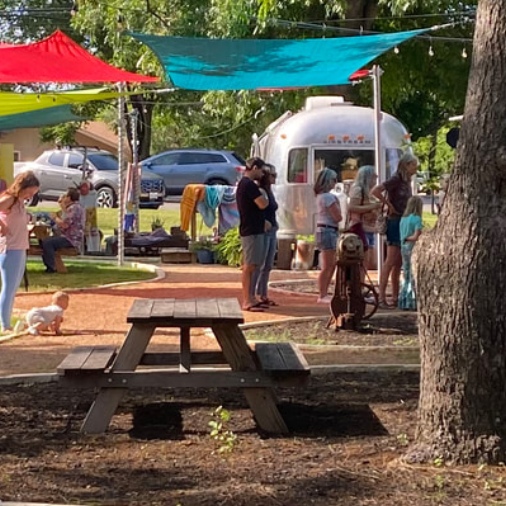 A picnic table and tents at a market