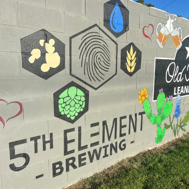  A cement wall with colorful graphics and letters