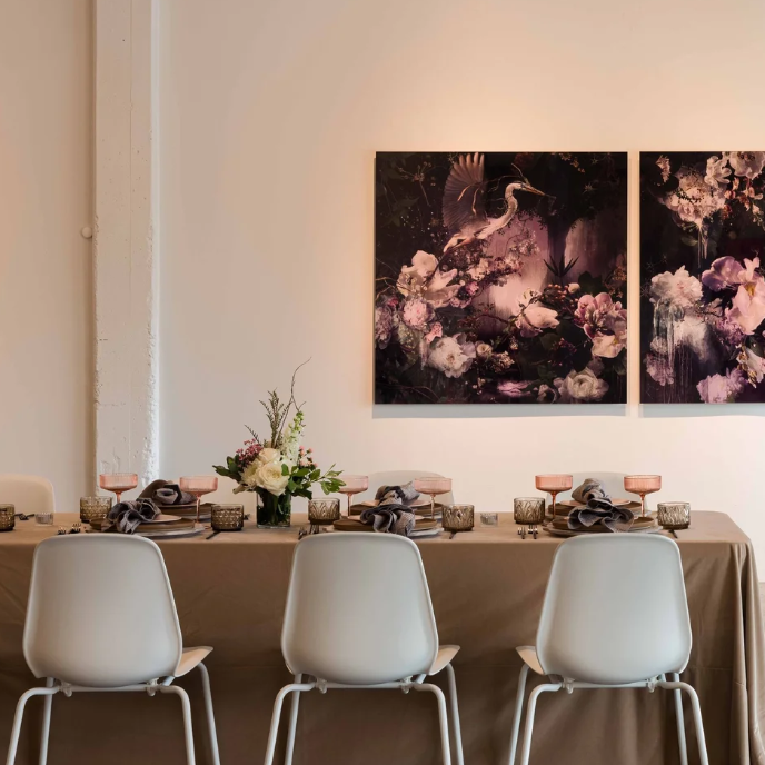 A venue with a set dinner table and art on the walls