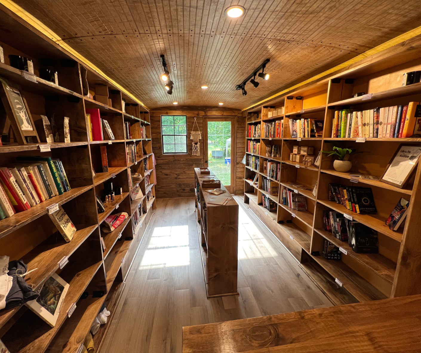 A long narrow room filled with shelves filled with books.