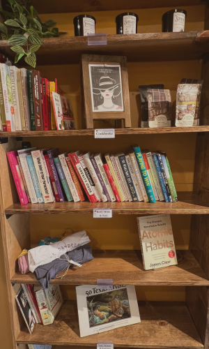 A bookshelf filled with lots of books and candles.