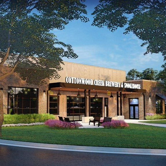 Cotton O' Neil Orthopedics & Sports Medicine clinic exterior at dusk with brick facade and landscaped entrance