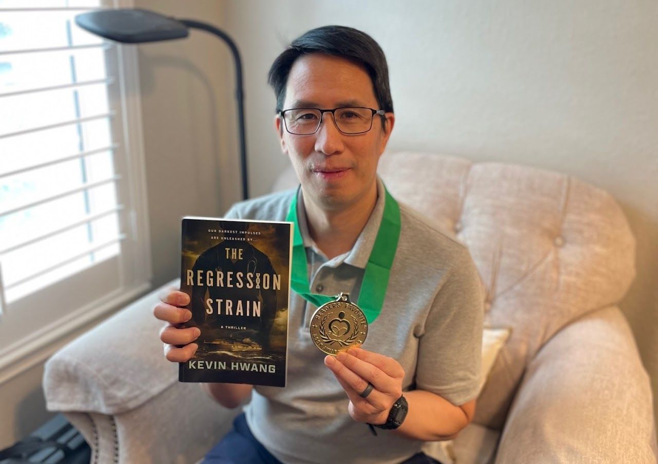 Man holding a book titled 